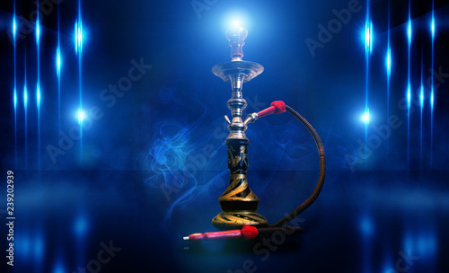 Hookah smoking on the background of a brick wall, concrete bola, in clouds of smoke and neon light
