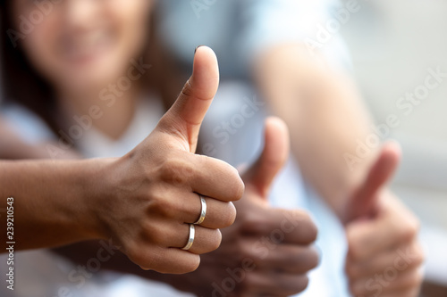 Happy multiethnic friends showing thumbs up close up, like, finger, gesture, recommendation of good choice, excited satisfied clients, successful teamwork, hands view, celebrate great deal