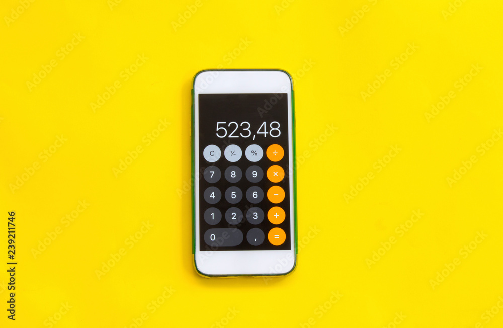 smart phone with calculator on yellow background - obrazy, fototapety, plakaty 