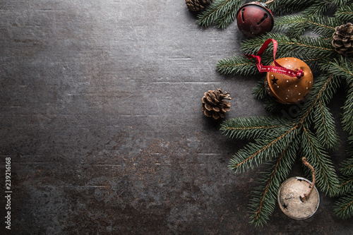 Top of view christmas decorations jingle bells fir tree pine cones on free concrete background photo