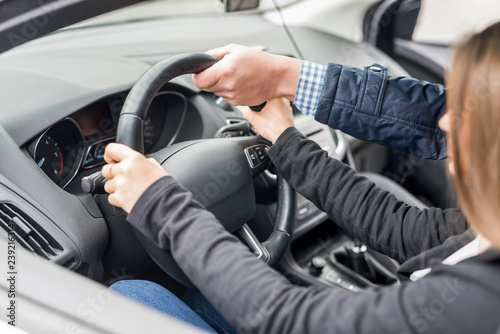 Instructor's hand helping drive to a woman