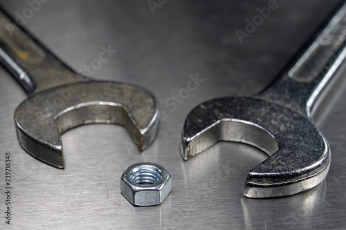 Wrench and nuts on a metal table in a workshop. Accessories for mechaics for minor mechanical repairs. photo