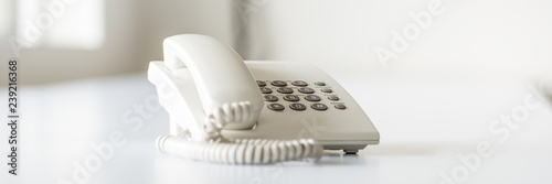 Wide view image of white landline telephone photo