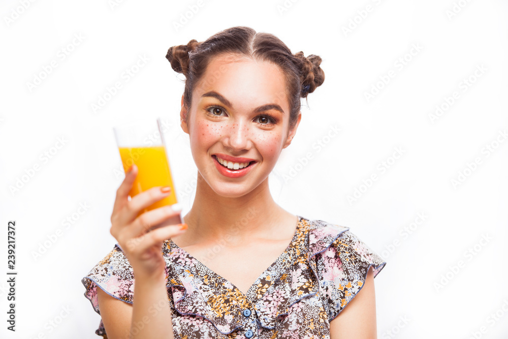 Woman drinking orange juice smiling happy excited. Beauty Teenager Model Girl. Beautiful Joyful teen girl with freckles and yellow makeup. Professional make up. Isolated on a white background Woman drinking orange juice smiling happy excited. Beauty Teenager Model Girl. Beautiful Joyful teen girl with freckles and yellow makeup. Professional make up. Isolated on a white background