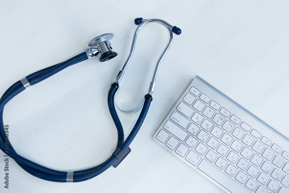 Stethoscope and keyboard on white background. Medical concept Stethoscope and keyboard on white background. Medical concept