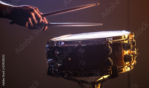 man playing the snare drum on a beautiful colored background photo