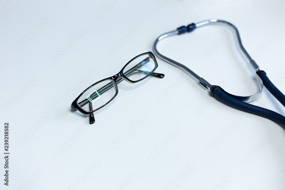 Stethoscope and closeup glasses on white background Stethoscope and closeup glasses on white background