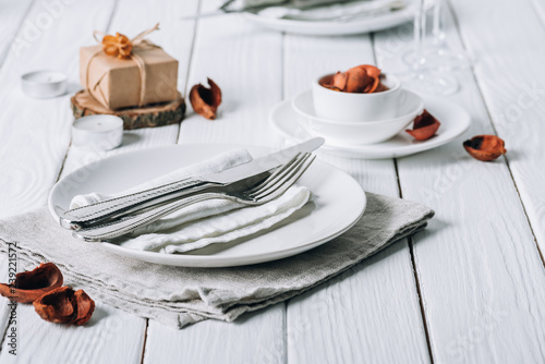 Christmas place setting on white rustic table