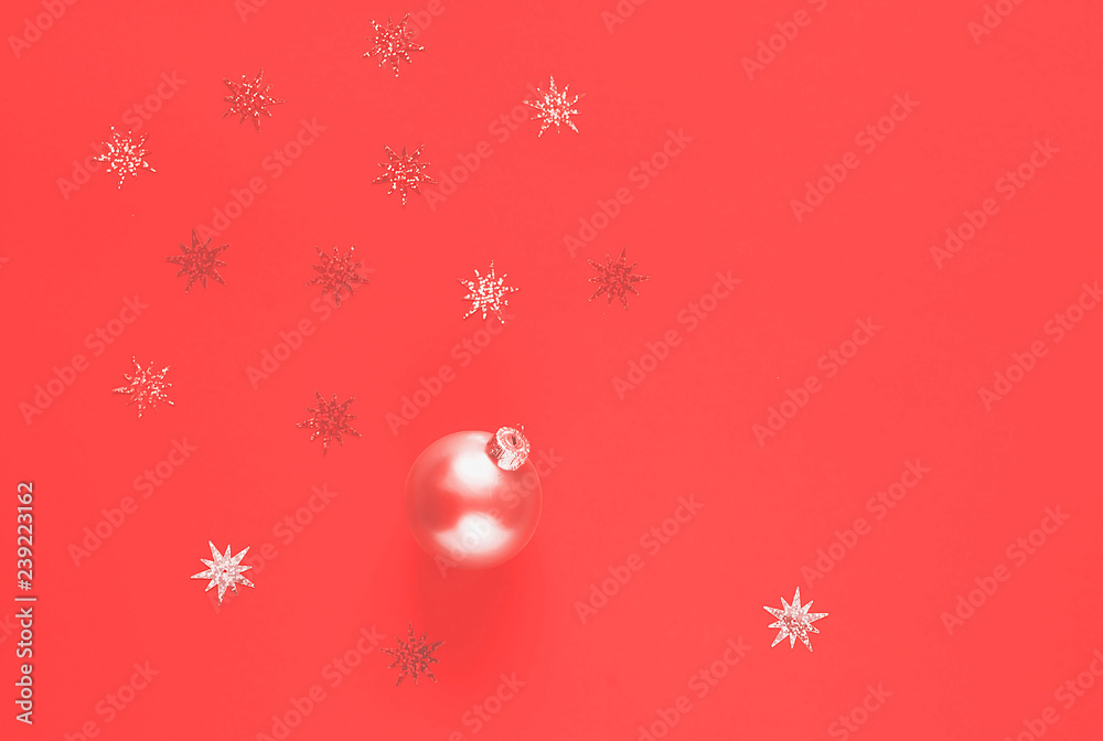Christmas decorations of from ball with sparkles on Coral background. Color of the year 2019 concept. Christmas decorations of from ball with sparkles on Coral background. Color of the year 2019 concept.