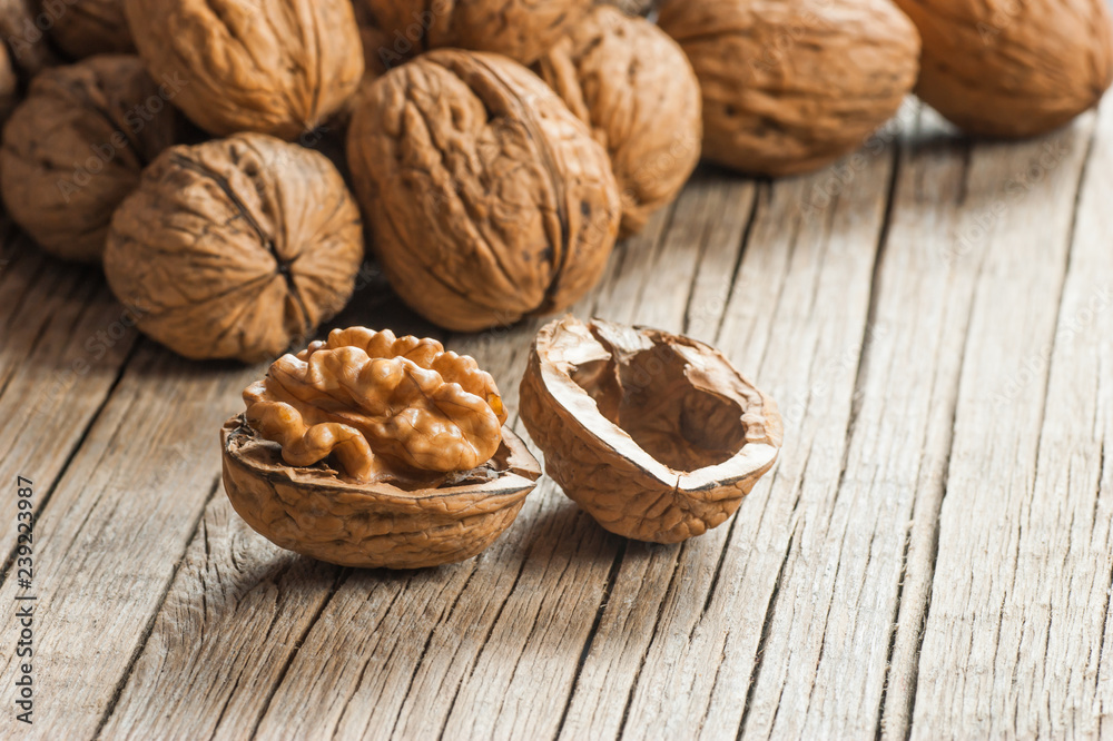 Pile whole big walnut kernel with thin shell on wooden vintage rustic backdrop. healthy food for brain. Fresh walnuts background concept Pile whole big walnut kernel with thin shell on wooden vintage rustic backdrop. healthy food for brain. Fresh walnuts background concept