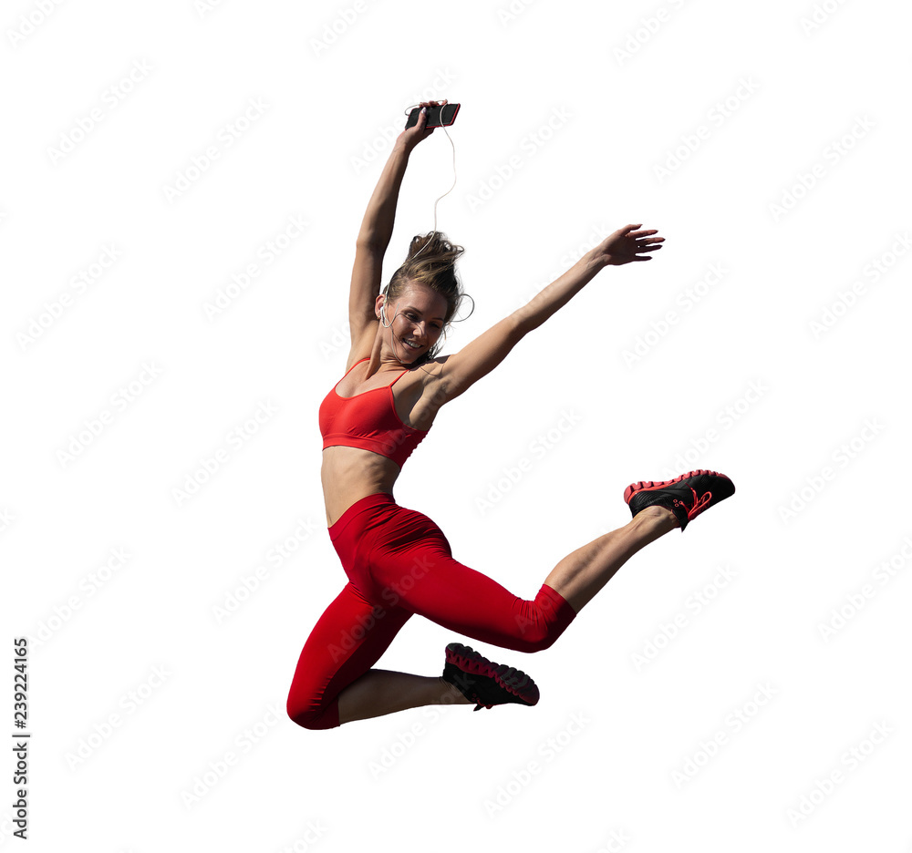 Young caucasian girl performs twine jumping on white background.
