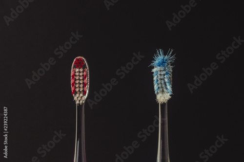 Used and new toothbrushes on a black background. The concept of changing toothbrushes  oral hygiene  dentistry. Family