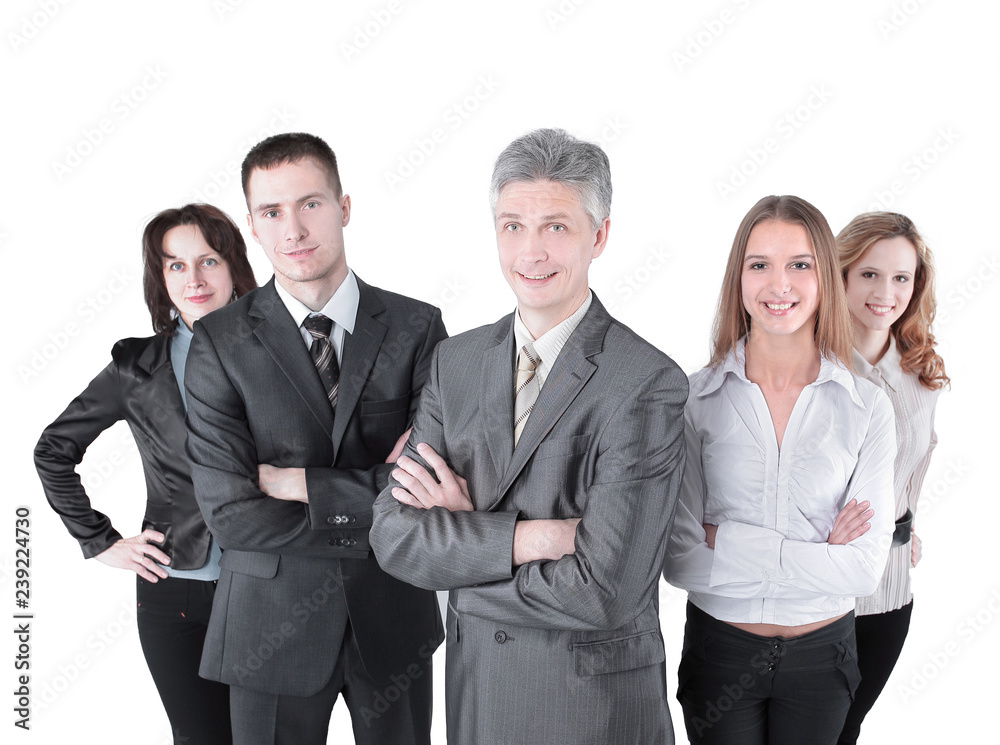 Team leader stands with coworkers in background Team leader stands with coworkers in background