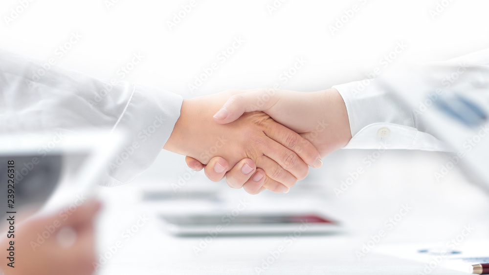 close up. handshake of financial partners after signing the cont close up. handshake of financial partners after signing the cont