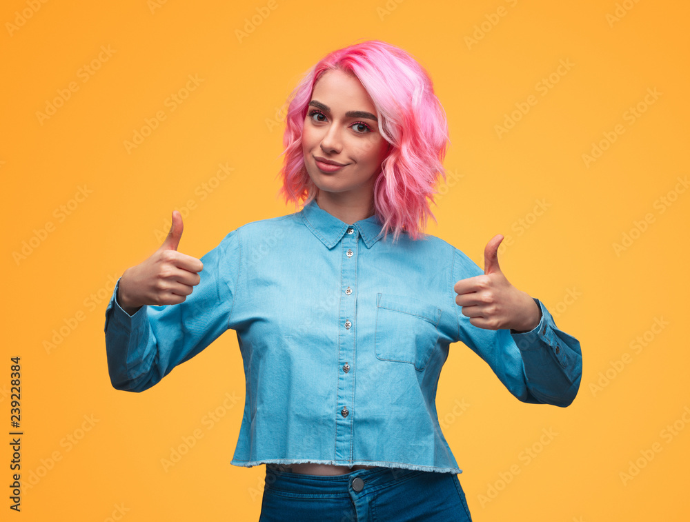 Lady with pink hair gesturing thumb-ups