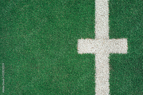 White marks and lines on green soccer or football field.  Copy space. Top view.