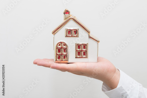 Woman hand holding house model