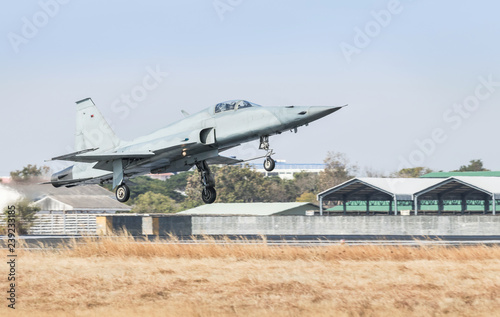 Billede på lærred Fighter jet military aircraft flying with high speed take off  from runway with