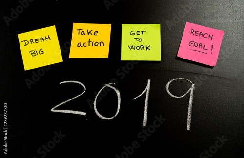 New Year resolutions or popular Goals and colorful sticky post its notes on chalk blackboard