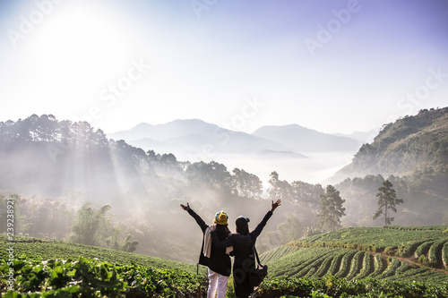 The 2 Asian female Travelers with The beautiful Landscape, strawberry plantation in the morning with the mist, at Ban Nor Lae, Doi Ang Khang, Chaing Mai, Thailand. Explore with best friend photo