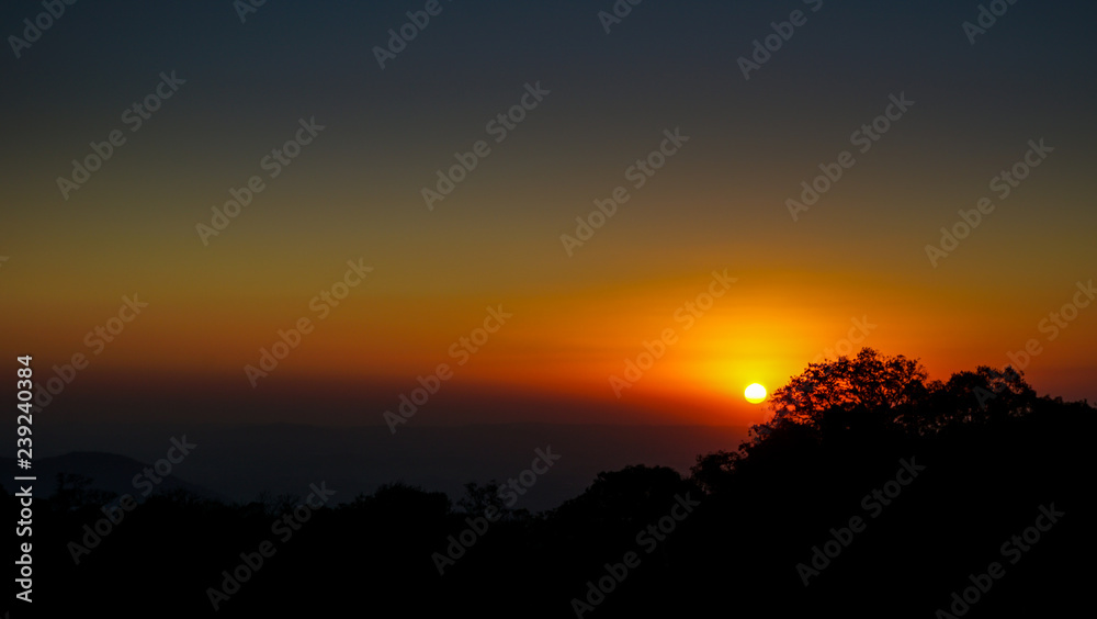 Sunset and tree silhouettes in Pico das Flores, Extrema, Brazil Sunset and tree silhouettes in Pico das Flores, Extrema, Brazil