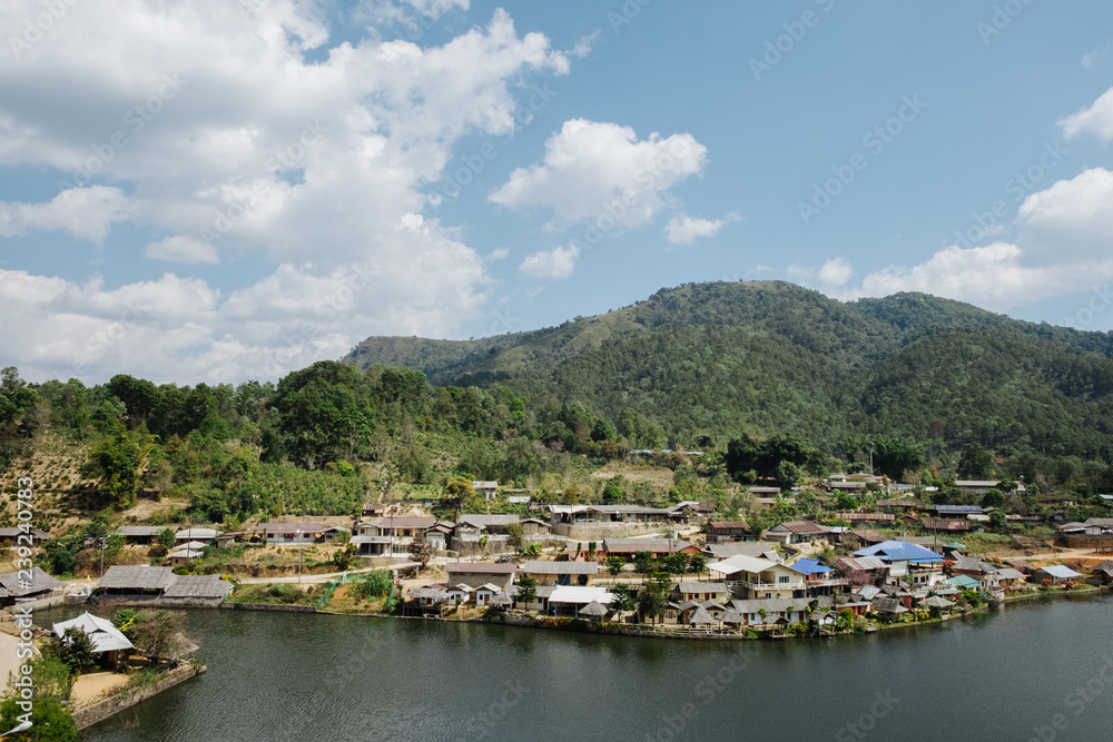 home town in the River with blue cloudy sky, Riverside view at Rak Thai Village, Mae hong son, Thailand