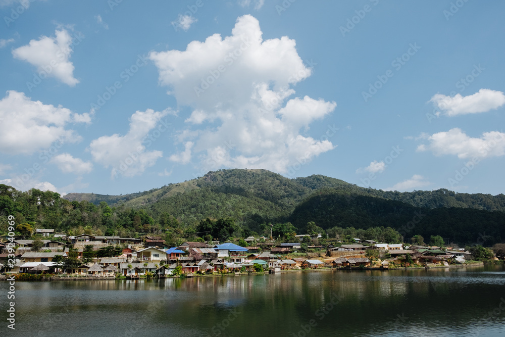 home town in the River with blue cloudy sky, Riverside view at Rak Thai Village, Mae hong son, Thailand