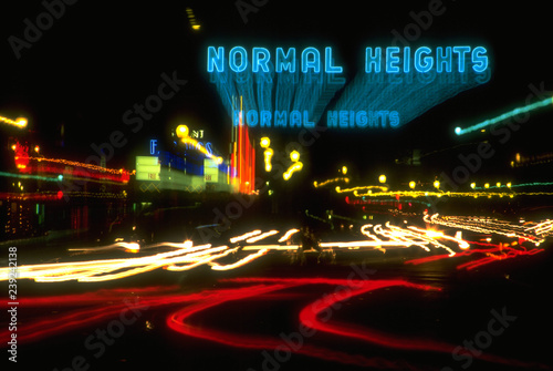 Картината върху платно Time lapse light trail photo of the traffic driving past the Normal Heights sign