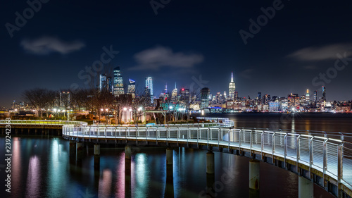 Pier C park in Hoboken, New Jersey by night, with the New York City skyline in the background.