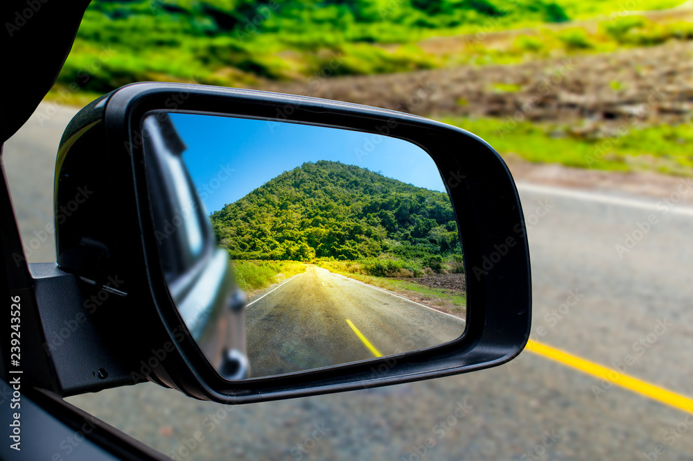 Landscape in the sideview mirror of a car