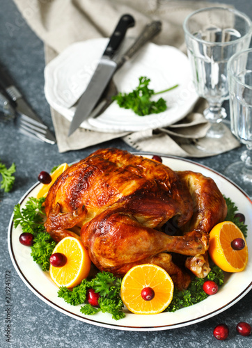 Roasted chicken served with citrus and cranberry on plate