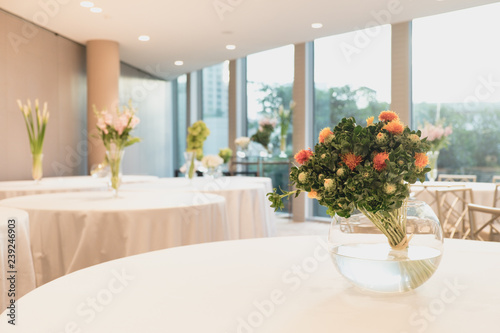 Bouquet of white flowers in a vase, candles. wedding home decor on a table