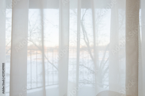 Defocused of curtain window and stationery box with sunlight in the winter season.