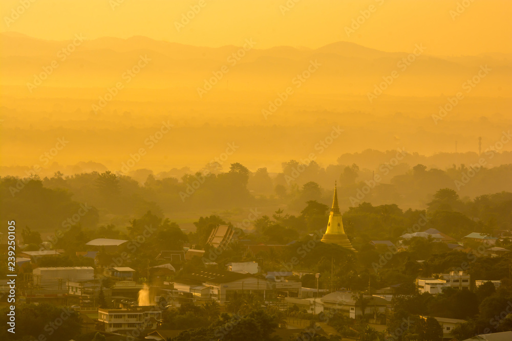 Obraz premium colorful sunrise over town with mountain range at background