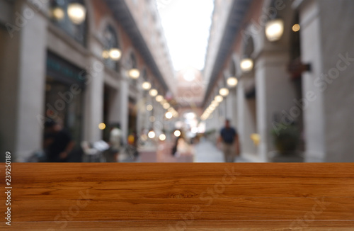 Empty wooden table in front of abstract blurred background of shopping mall and people . can be used for display or montage your products. Mock up for display of product - Image.