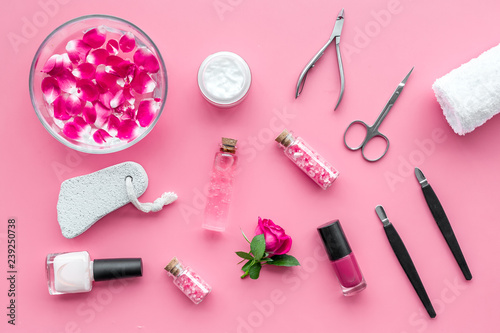 manicure tools set for nail care on rose background top view