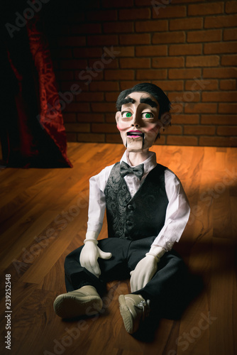 scary ventriloquist doll sitting on the floor photo