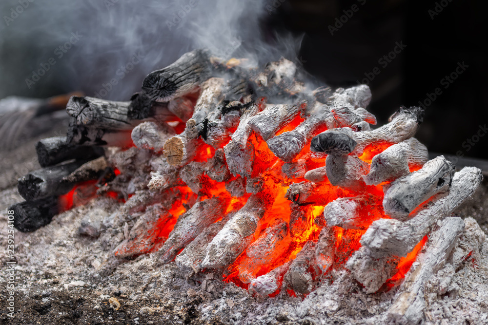 hot wooden embers with smoke for barbecue