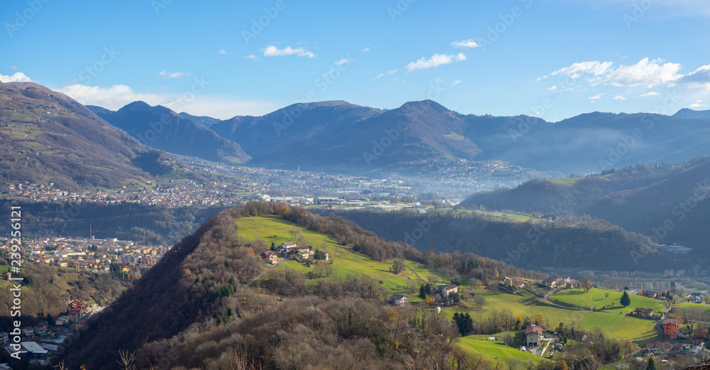 Drone aerial view to the Seriana and Gandino valley in fall season. Landscape from the village of Orezzo, Bergamo, Italy