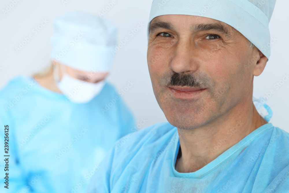Boss surgeon is examining the operation while medical team are busy of patient. Medicine, healthcare and emergency in hospital Boss surgeon is examining the operation while medical team are busy of patient. Medicine, healthcare and emergency in hospital