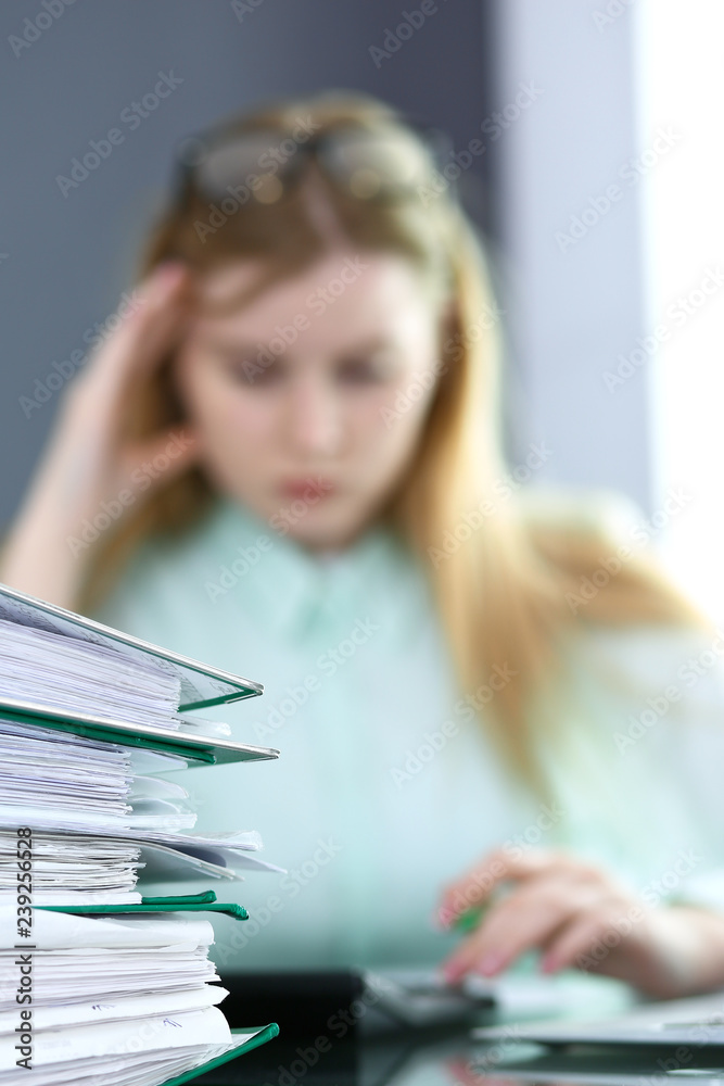 Bookkeeper or financial inspector making report, calculating or checking balance. Audit and tax service concept. Green colored image background Bookkeeper or financial inspector making report, calculating or checking balance. Audit and tax service concept. Green colored image background