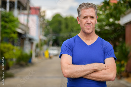 Mature man with arms crossed in the streets outdoors