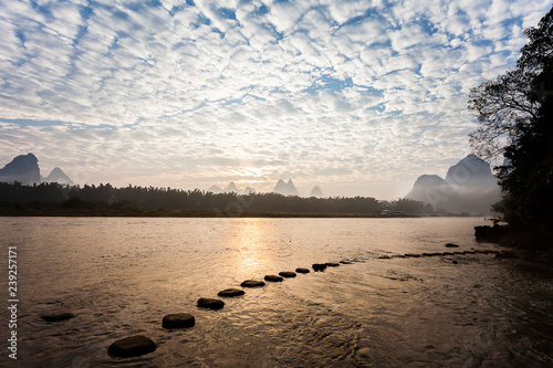Принти на полотні Early morning altocumulus clouds ,river  and stepping stone