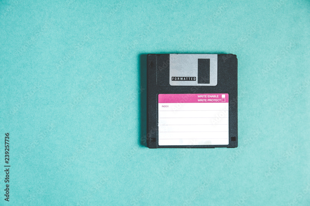 Old floppy disks for computer on green background Old floppy disks for computer on green background