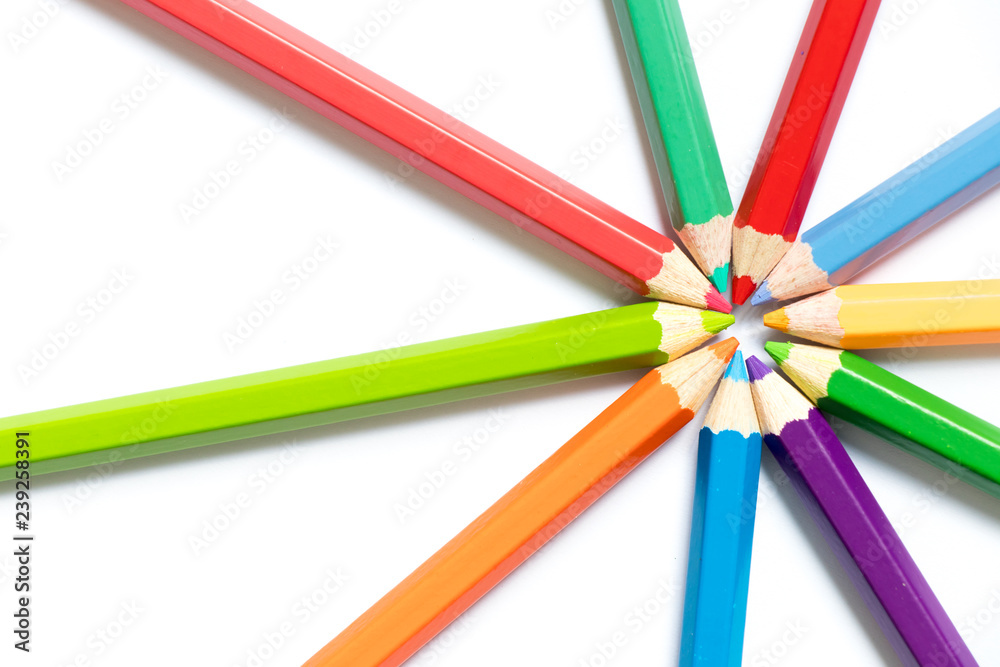 Color pencil arrange in ray shape on white paper background Color pencil arrange in ray shape on white paper background