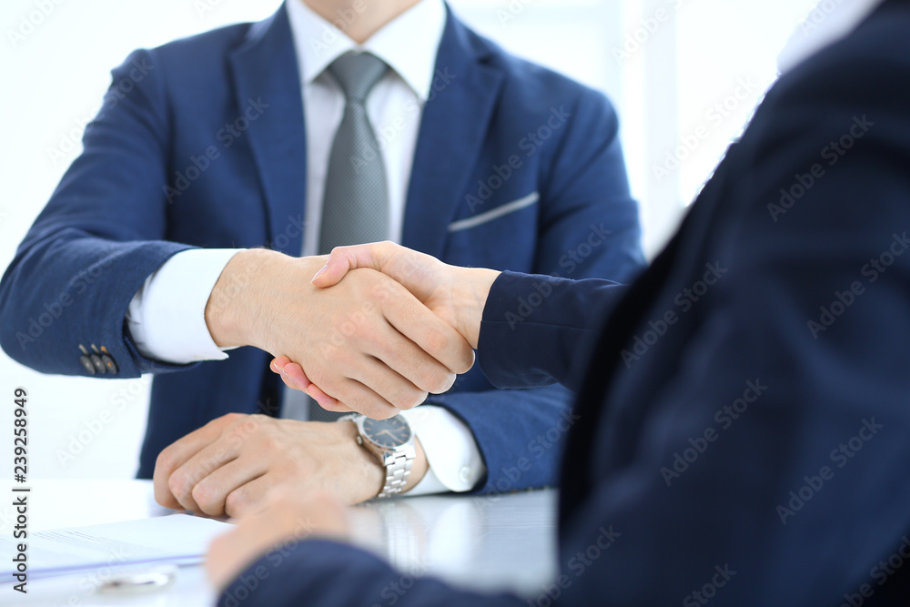 Group of business people or lawyers shaking hands finishing up a meeting , close-up. Success at negotiation and handshake concepts