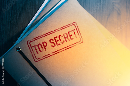 private detective desk with envelopes labeled as top secret photo