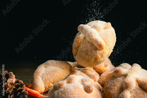 Mexican bread known as "pan de muerto" on a wooden background