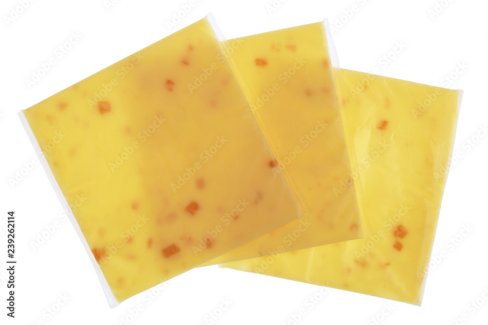Plates of melted cheese with pieces of bacon in square plastic bags isolated
