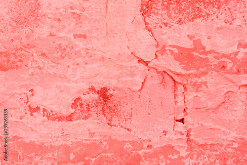 Texture  wall  concrete  living coral. It can be used as a background . Wall fragment with scratches and cracks